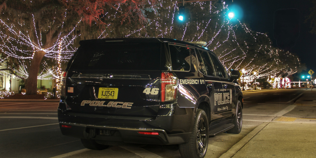 St. Augustine Police marked patrol vehicle #46 parked next to the Plaza de Constitution at night during the Nights of Lights Event.